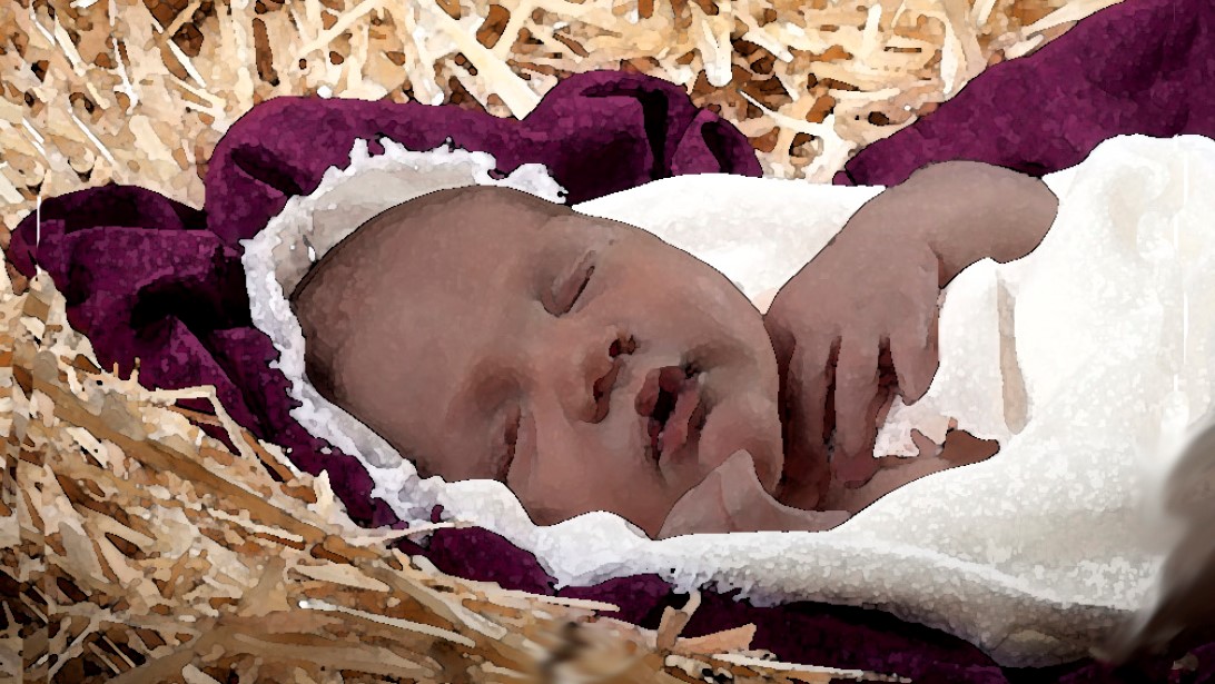 A baby wrapped in a white cloth sleeps on a bed of straw, partially covered by a purple blanket.