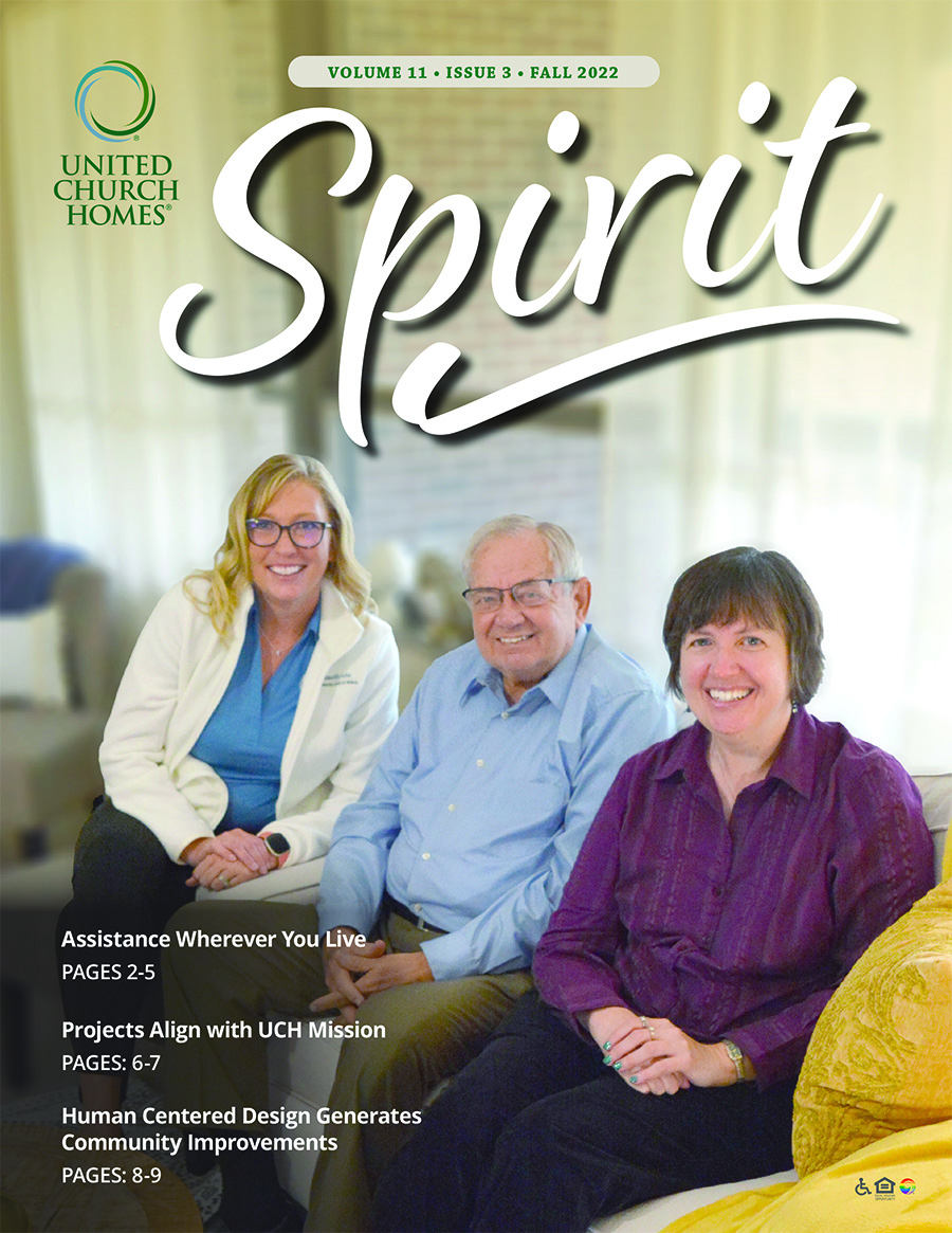 Cover of "Spirit" magazine, Fall 2022 issue. Three people sitting on a couch in a bright living room, smiling at the camera. Text highlights articles on assistance, mission-aligned projects, and design improvements.