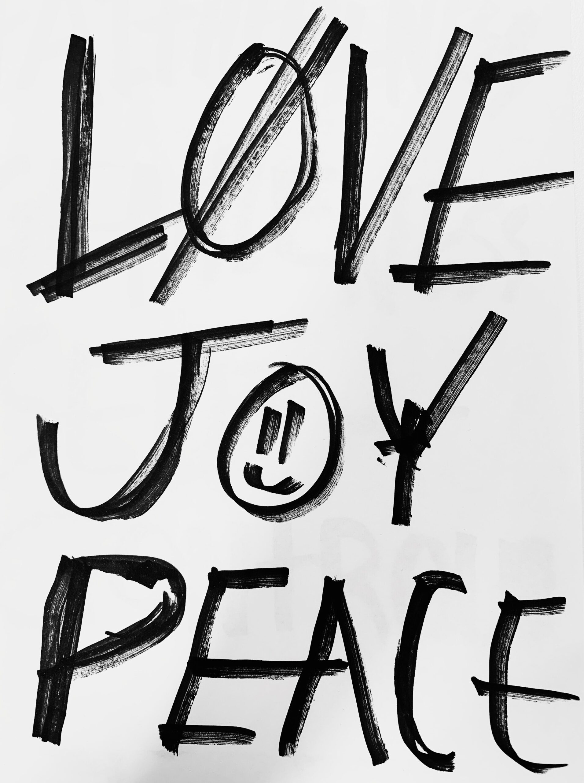 Black handwritten words "LOVE JOY PEACE" on a white background, with a smiley face inside the O of JOY.